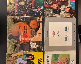 Assorted rock vinyl albums with colorful cover artwork.