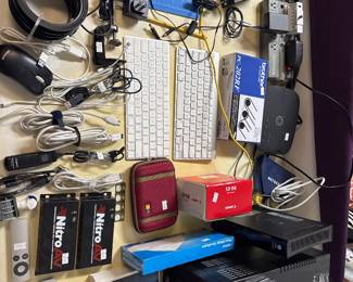 Assorted cameras, electronics, cases, cables, and small accessories.
