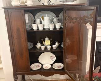 Vintage China Cabinet & Fine China Collection Beautiful vintage wooden china cabinet with decorative glass doors, carved details, and display shelving. Featuring an assortment of vintage china, including floral-patterned dinnerware, teacups, saucers, teapots, serving platters, and elegant decorative pieces. Perfect for antique lovers and vintage collectors! $125
