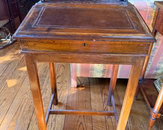 Antique-Style Mahogany Slant-Front Writing Desk with Pierced Gallery — Charming compact writing desk featuring a hinged slant-front writing surface, decorative pierced back gallery, fitted interior with two small drawers, correspondence-retaining cords, tapered legs, and lower stretchers. Warm mahogany finish with age-related wear.
