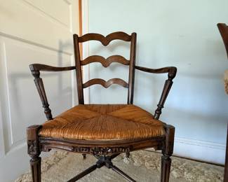 French Provincial style rush-seat armchair, often referred to as a ladder-back or wavy-slat fauteuil