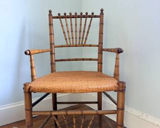 Vintage bamboo-style spindle-back armchair with a woven cane or rattan seat