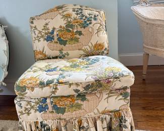 Vintage upholstered chauffeuse (often called a slipper chair or vanity chair) featuring a gathered dust ruffle skirt and a classic chintz floral pattern