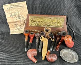 A Collection of Pipes and a Wood Sign Also a Book on How to Smoke a Pipe with Ashtray