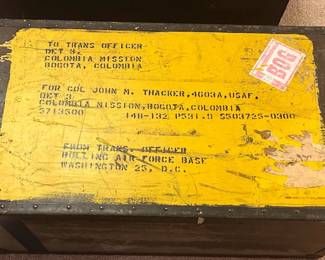 Several military footlockers and shipping containers