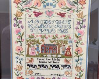 framed and signed needlepoint