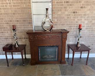 Vintage style fireplace and tv stand, side brown tables (there are 3 total), decorated candle holders (there are other matching pieces in the home).