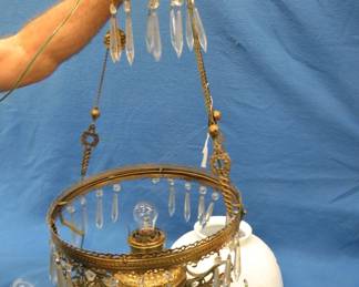 Lot 244. Antique electrified hanging oil lamp. Prisms and shade are in good condition.