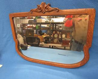 Lot 100. Vintage beveled mirror in an oak frame