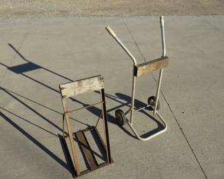 Lot 200. Two outboard motor stands. One with wheels.