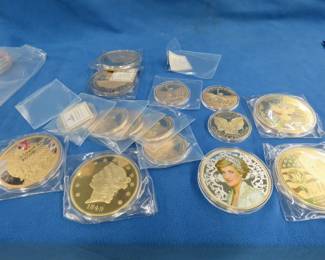 Lot 152. Gold-layered coins: 2016 Princess Dianna coin 366 grams made with silver or gold plating. Six jumbo copper coins with layered gold about 13-14. ounces each. Colossal Coin Collection 14 coins each made copper and layered with 24K gold each over. 4 ounces