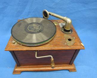 Lot 104. Antique wind-up record player. Works. Needs a needle.