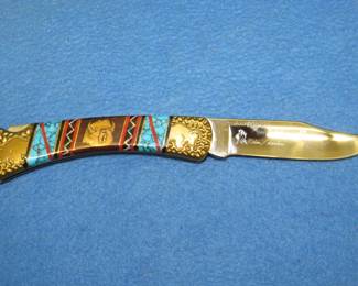 Lot 194. Buck Knife with a custom handle designed by Brian Yellowhorse. Numbered 0004/2000.