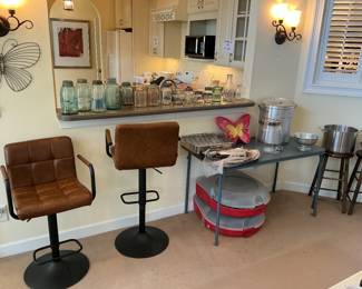 Two barstools and Christmas wreath storage containers