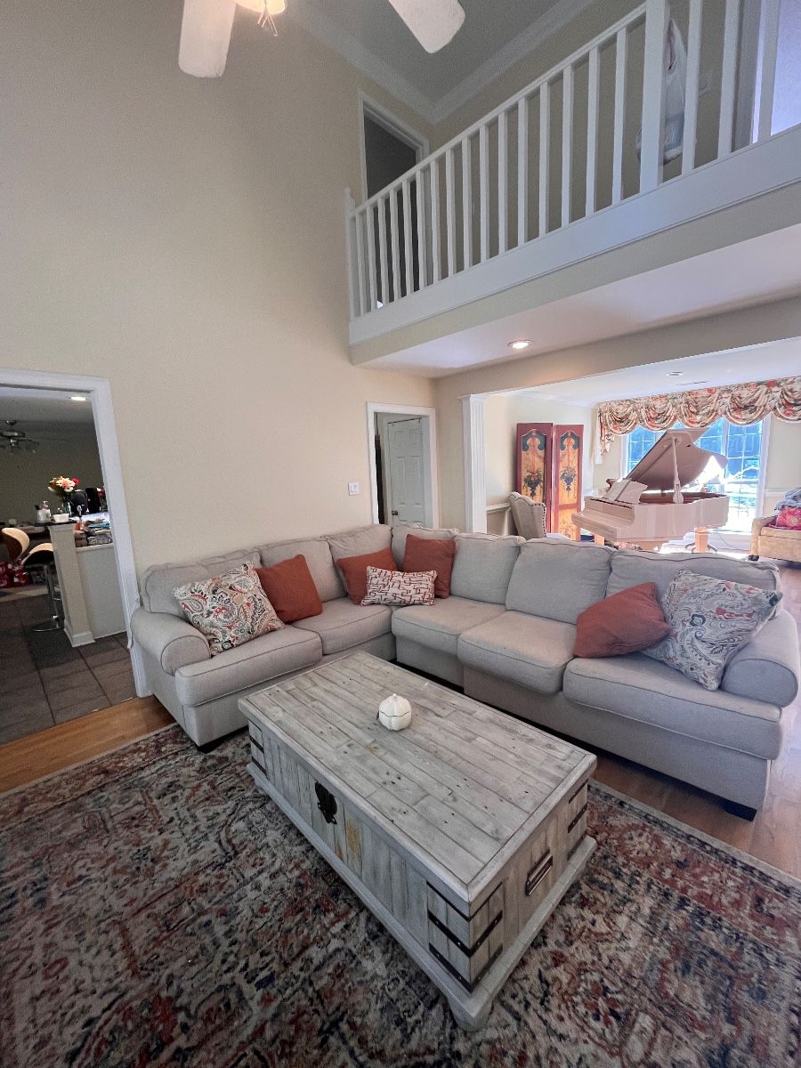 Sectional living room set. Large area rug. Accent pillows. Coffee table.
