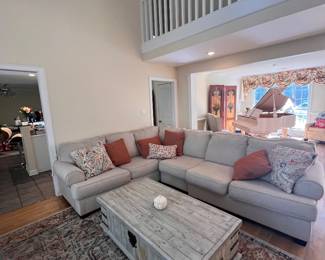 Sectional living room set. Large area rug. Accent pillows. Coffee table.