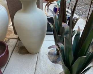 A Large Unglazed Ceramic Vase and Two Large Metal Flower Decor Pieces
