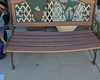 A Decorated Outdoor Wrought Iron Sitting Bench