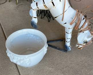 A Small Metal Handcrafted Zebra and a White Plant Pot