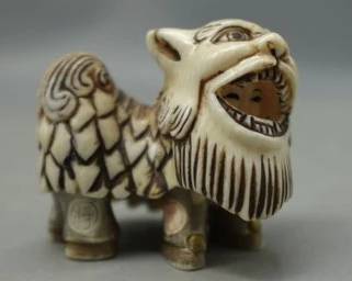 RARE ARTIST SIGNED JAPANESE IVORY NETSUKE FESTIVAL COSTUME BEAST WITH CHILD PERFORMER