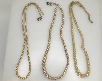 Three knotted pearl necklaces