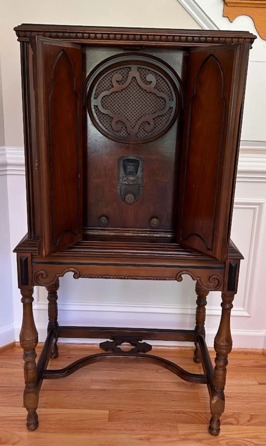 Antique floor-standing radio in an ornate wooden cabinet