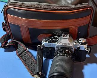 Canon AE-1 35mm film SLR camera with a telephoto zoom lens