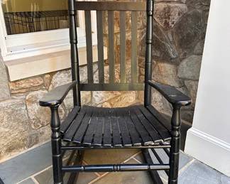One of two black rocking chairs