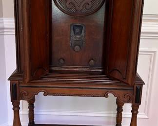 Antique floor-standing radio in an ornate wooden cabinet