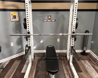 Power rack/squat rack with bench, bar and visible plates