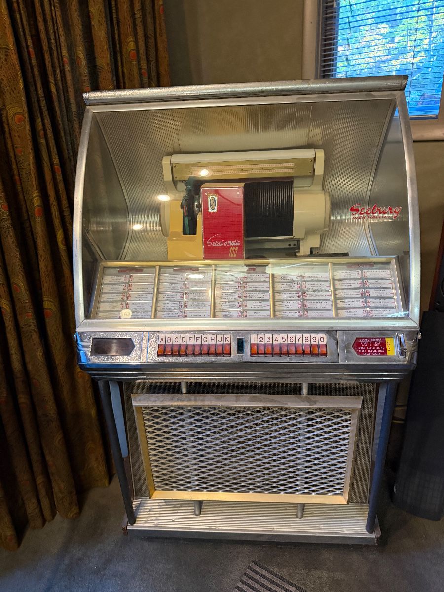 Vintage jukebox with chrome front and lighted title display