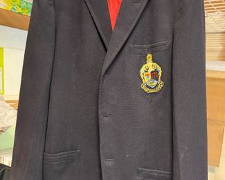 Navy blazer with a crest patch pocket