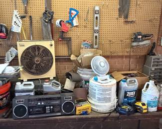 Workbench with box fan, radio and garage supplies