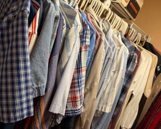 Closet of mens dress shirts on hangers