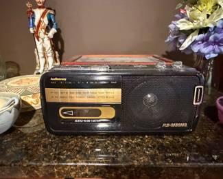 Portable radio and a Colonial soldier figurine on a counter