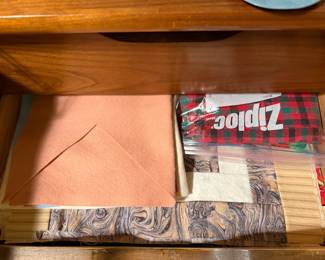 Drawer of folded backing fabric and storage bags