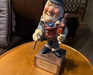 Painted figurine of a man with a bottle
