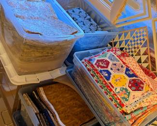 Bins of quilt blocks and pieced hexagon units