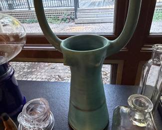 Art pottery vase and glass canisters on a windowsill