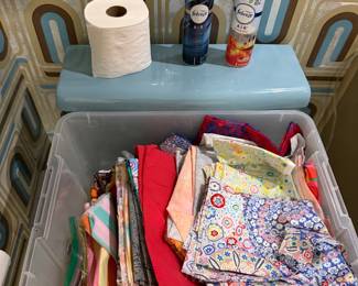 Bin of folded quilting cotton in a bathroom