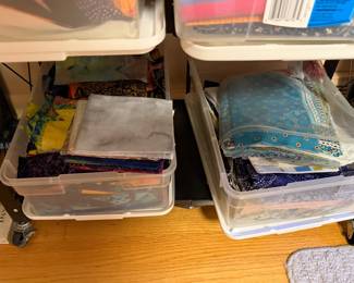 Bins of folded fabric and quilt backing