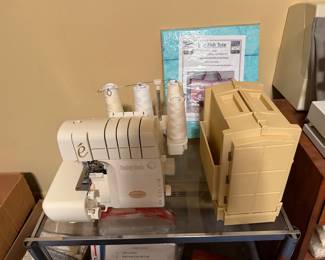 Serger with thread cones and storage boxes