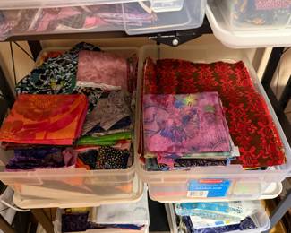 Bins of folded fabric in brights and batiks