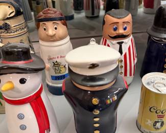 Character steins including a snowman and a Marine