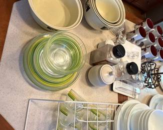 Pyrex and glass mixing bowls with kitchen storage