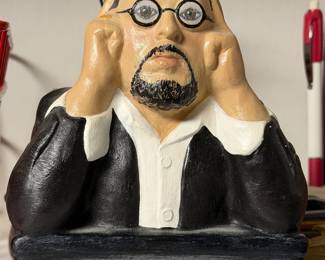 Comic resin figure of a stressed man in a suit