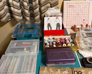 Quilting frames, rulers and thread caddy on a work table