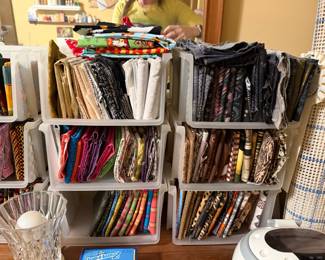 Wall racks of sorted fat quarters and fabric bundles