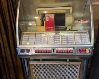 Vintage jukebox with chrome front and lighted title display