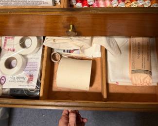 Drawer of bobbins, tape and sewing notions